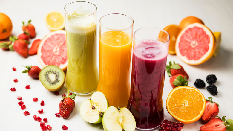 Fruit smoothies surrounded by fruit