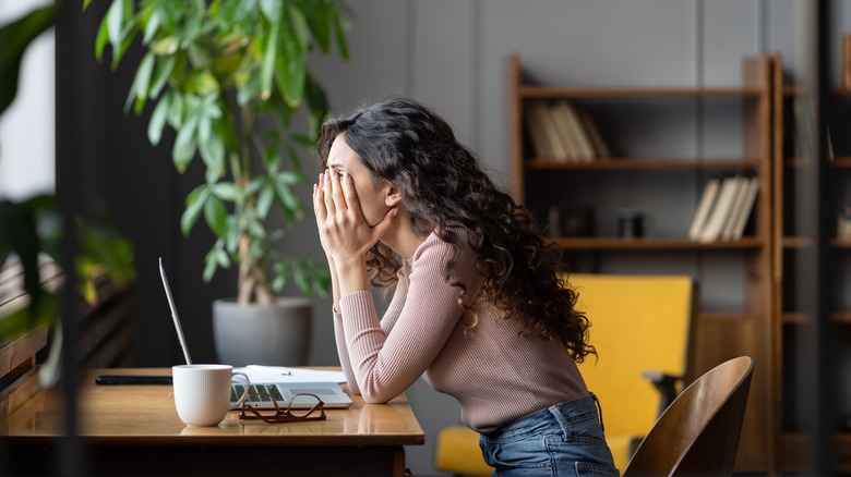 Disappointed woman sitting at desk