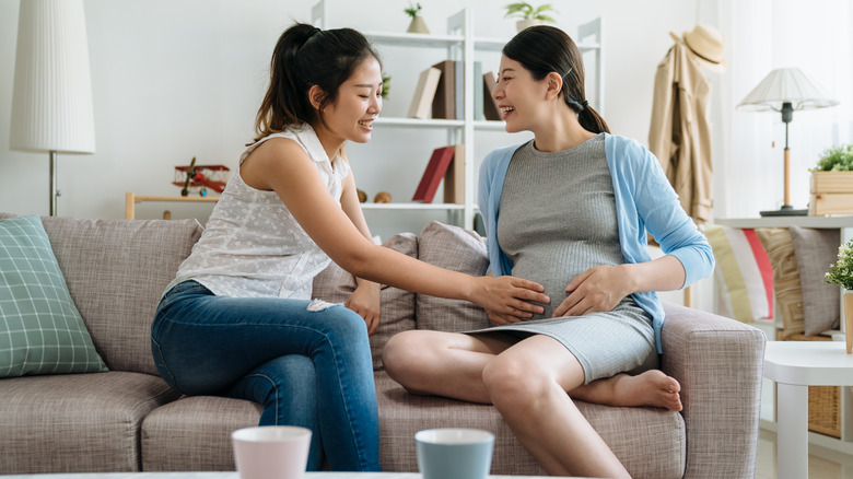 pregnant woman sitting with friend