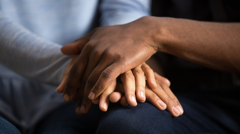 Couple holds hands