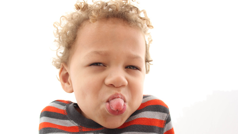 Child sticking out tongue
