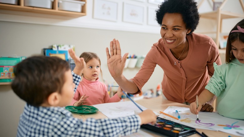 Teacher giving high five to student