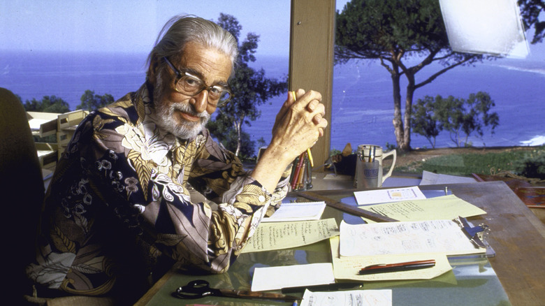 Theodor Seuss Geisel posing at his desk 