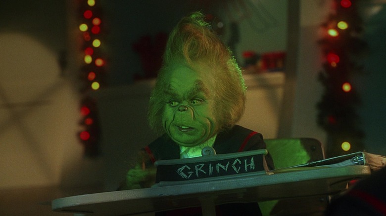 Still image of the young Grinch at a desk 