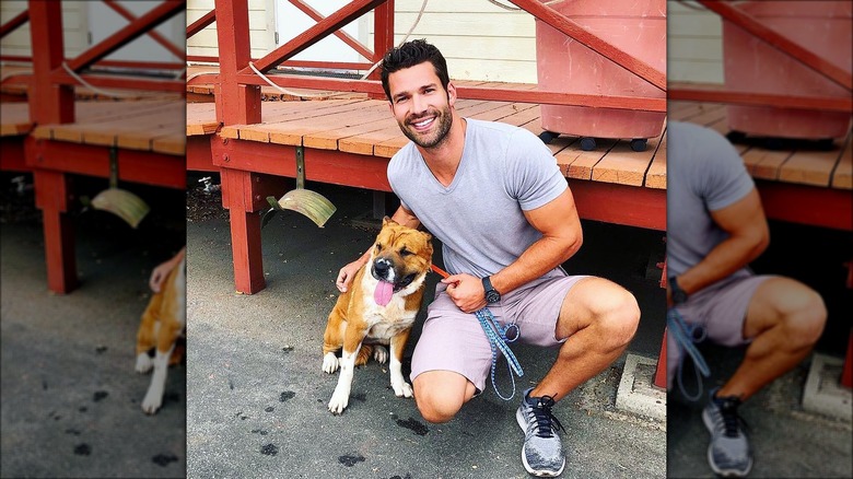 Aaron O'Connell posing with a rescue dog 