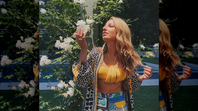 Vanessa Lengies looking at flowers