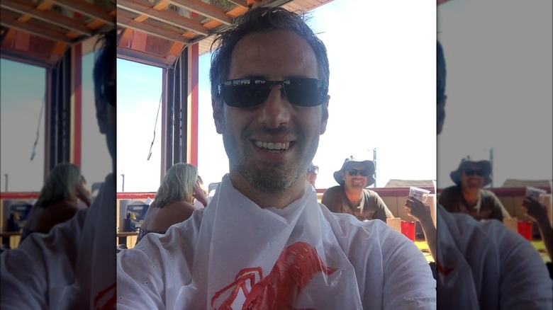 Josh Saviano at restaurant outside, smiling