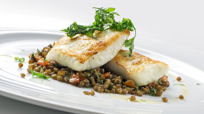 white fish over lentils