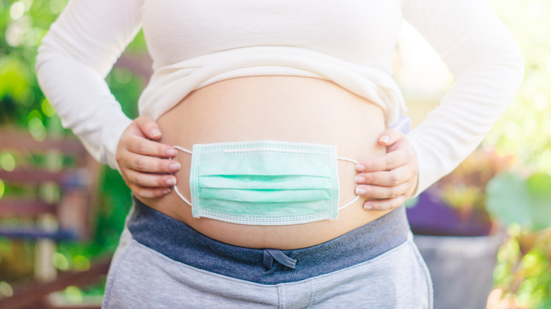 Pregnant woman's belly face mask