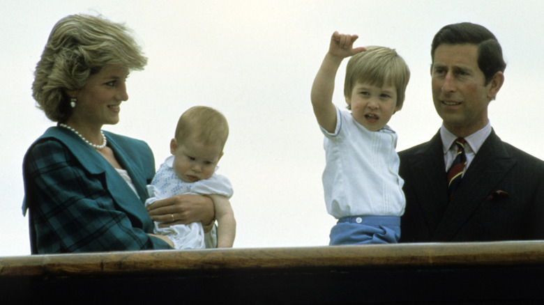 Prince Charles and Princess Diana hold their young sons