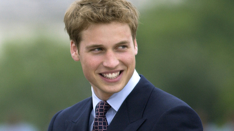 Young ﻿﻿Prince William smiling after watching the parade to mark the Queen's Golden Jubilee from the Queen Victoria memorial .