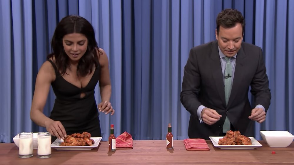Priyanka Chopra and Jimmy Fallon having a wing eating contest