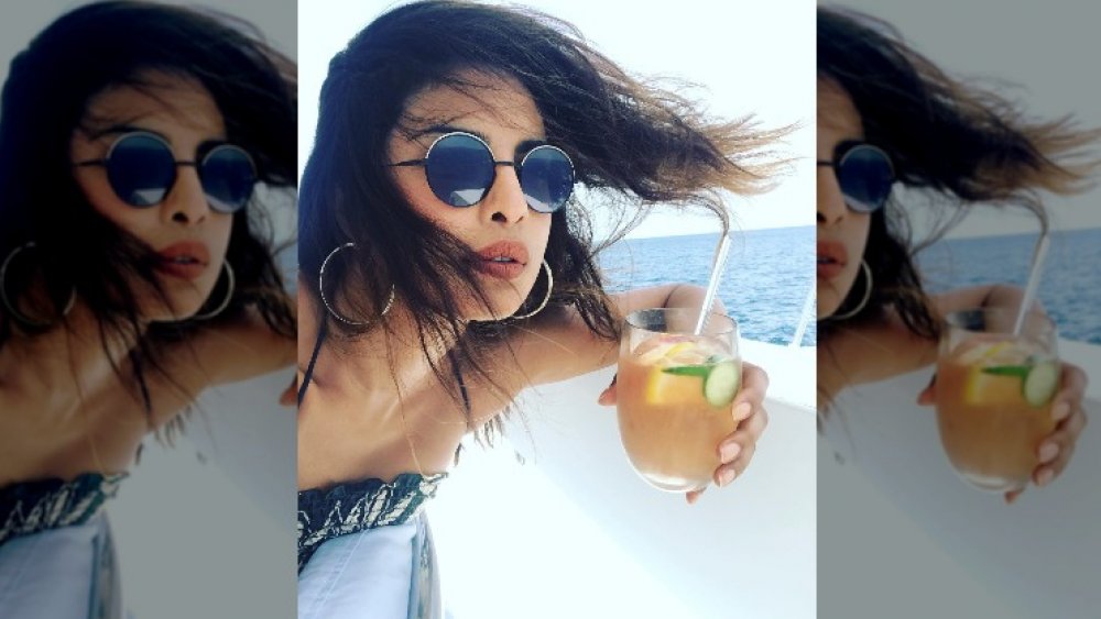 Priyanka Chopra with a drink by the water