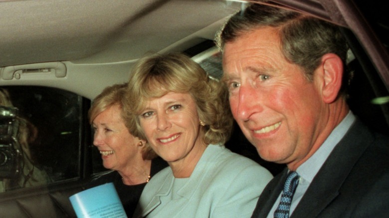 Camilla and Charles smiling in car, 1990s