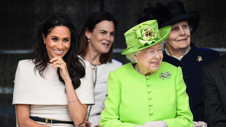 Meghan Markle, Queen Elizabeth II, and Samantha Cohen at public event