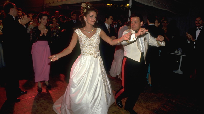 Queen Rania and King Abdullah dancing on wedding day