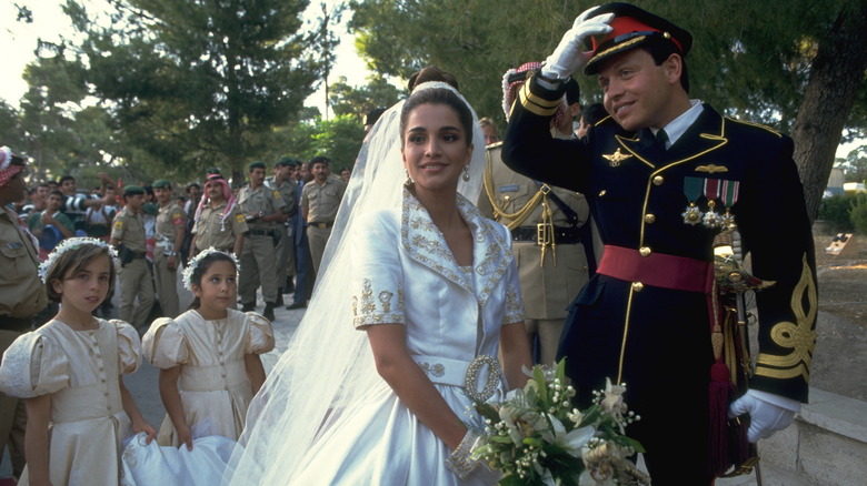 Queen Rania and King Abdullah smiling on wedding day