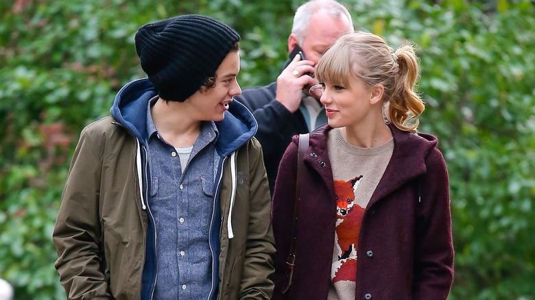 Harry Styles and Taylor Swift looking at each other