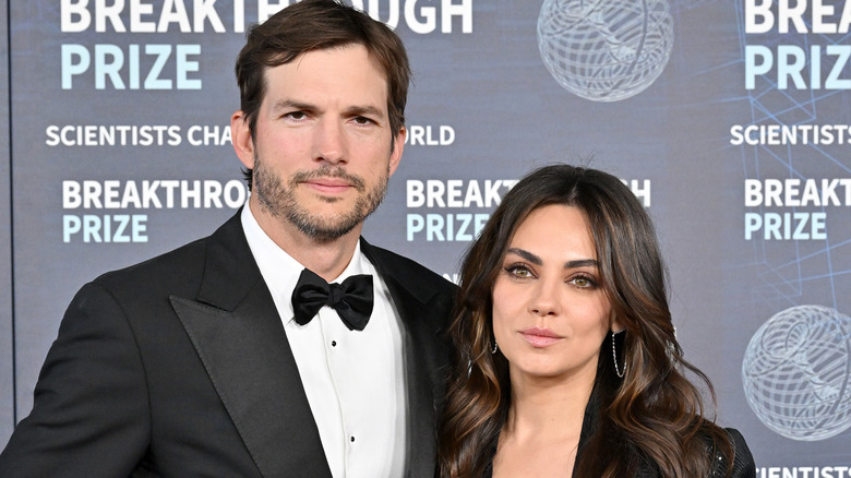 Ashton Kutcher and Mila Kunis posing