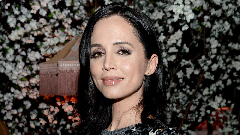 Eliza Dushku in front of a piano