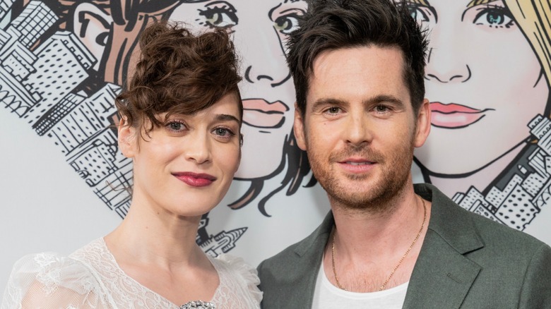 Lizzy Caplan and Tom Riley on a red carpet