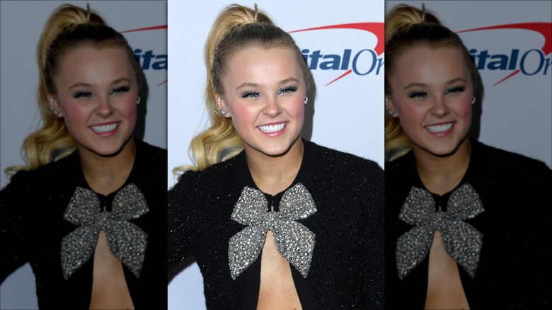 JoJo Siwa with a ponytail and a bow on her shirt