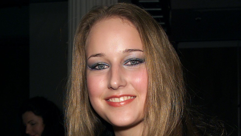 Leelee Sobieski smiling, wearing heavy makeup