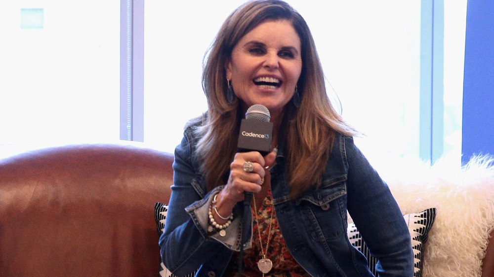 Maria Shriver holding a microphone