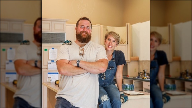 Erin and Ben Napier pose in a remodeled kitchen