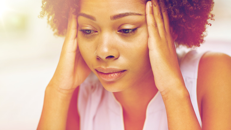 woman with headache uncomfortable