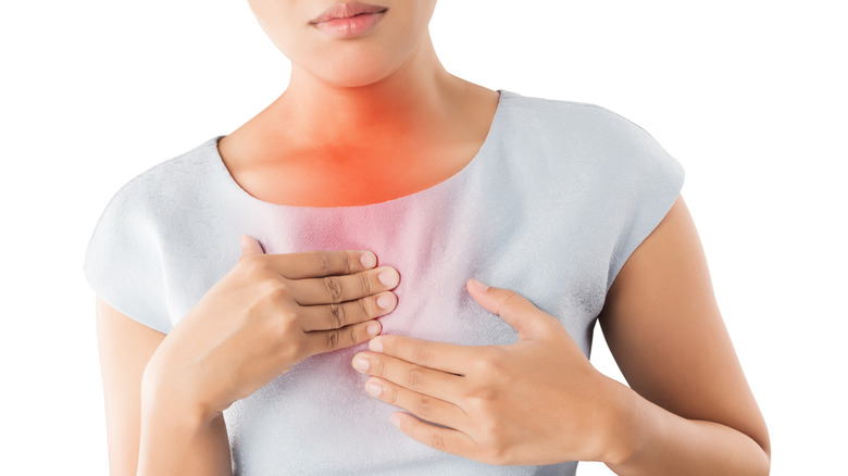 a woman experiencing acid reflux
