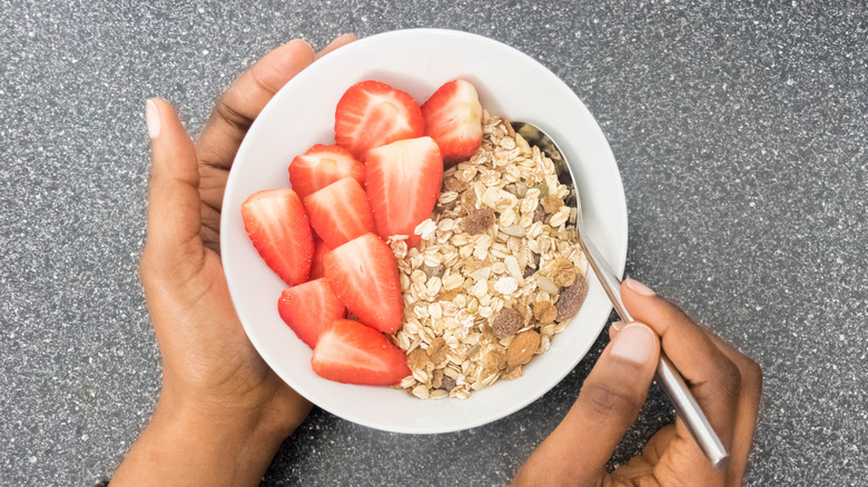 hands holding bowl of oatmeal