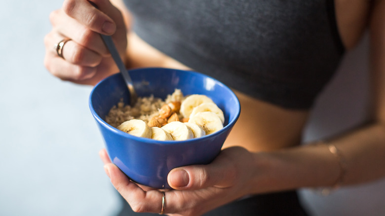 woman eating oatmeal before exercising