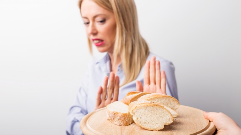 woman pushing away food not hungry no appetite