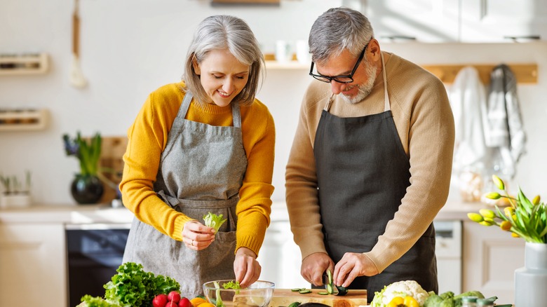 A happy couple cooking