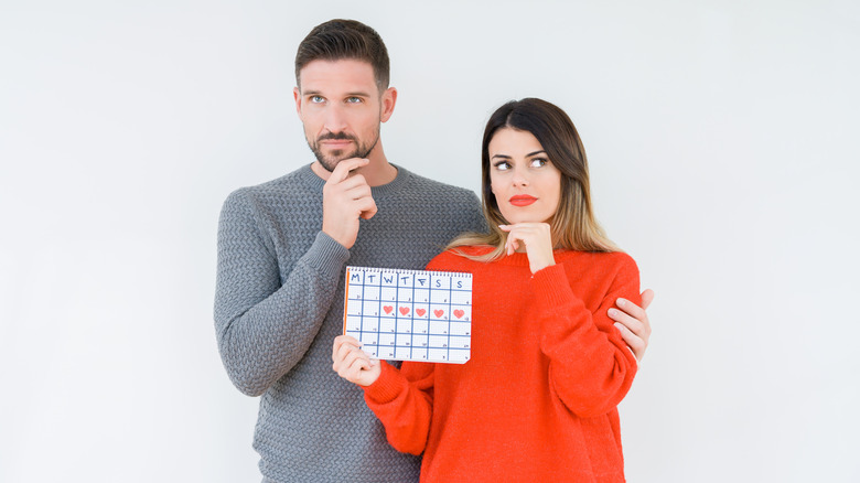 A couple with an ovulation calendar