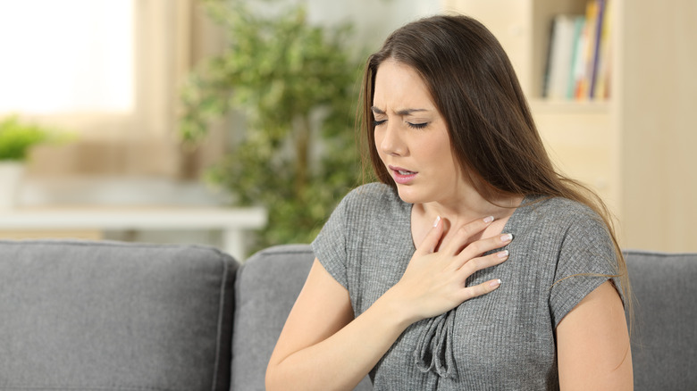 Woman clutching her chest