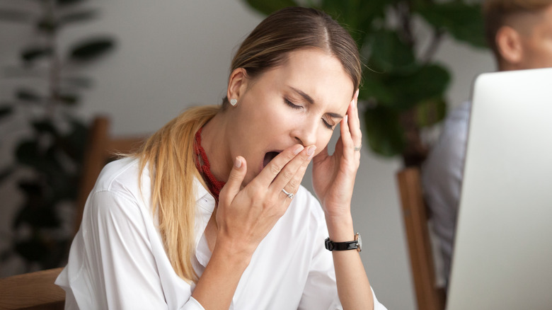 A woman yawning 