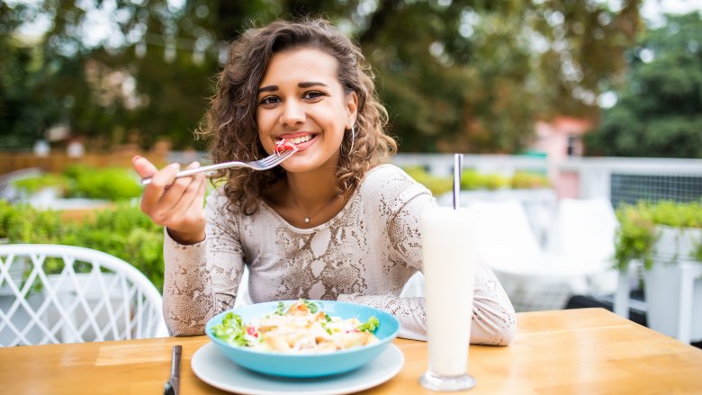 A woman eating outdoors