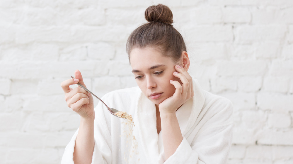 woman looking at her cereal