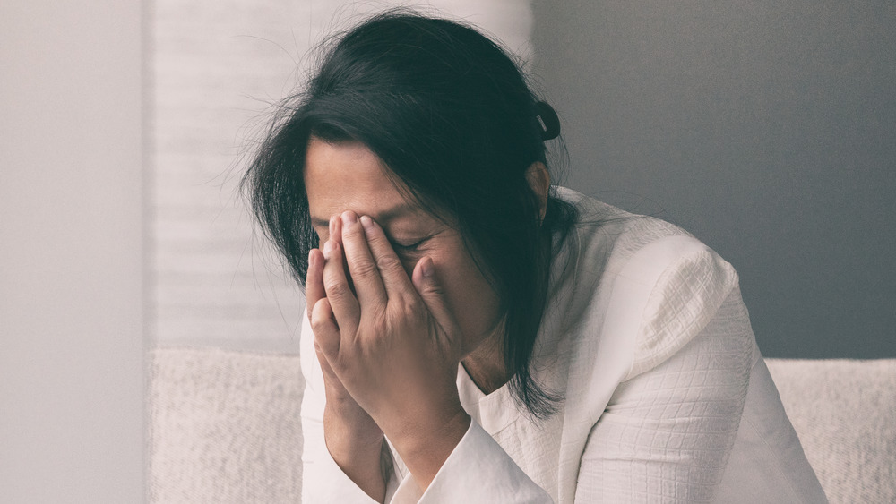 woman holding her forehead