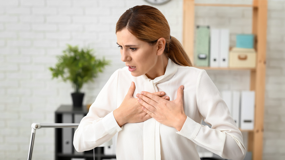 woman clutching her chest