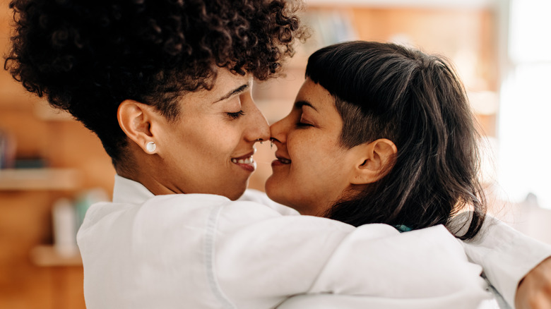 women affectionately hugging