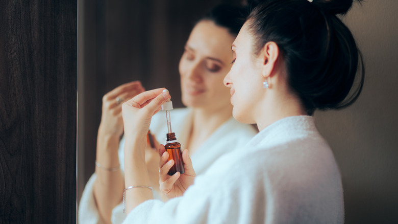 A woman applying skin care