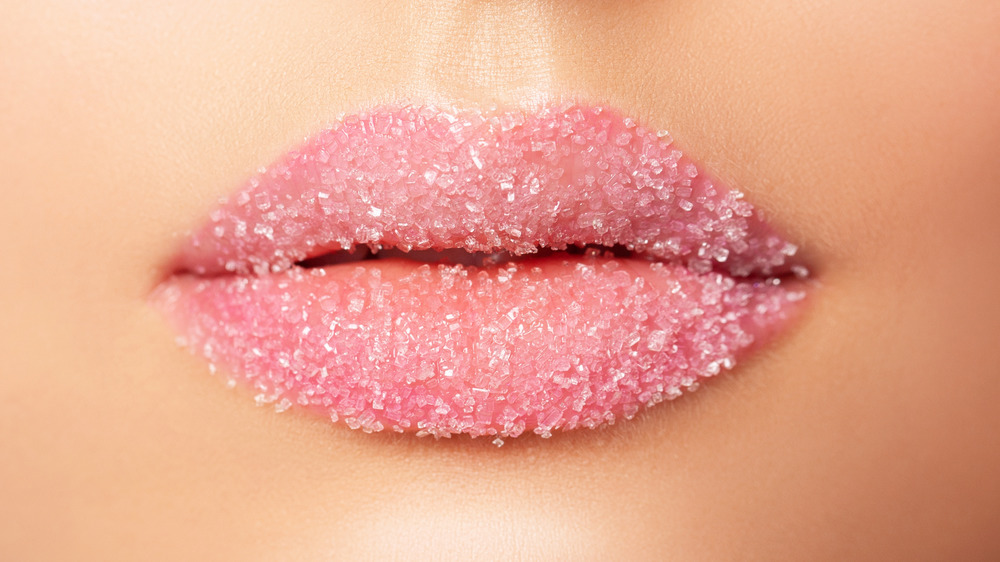 Sugar scrub on pink lips 