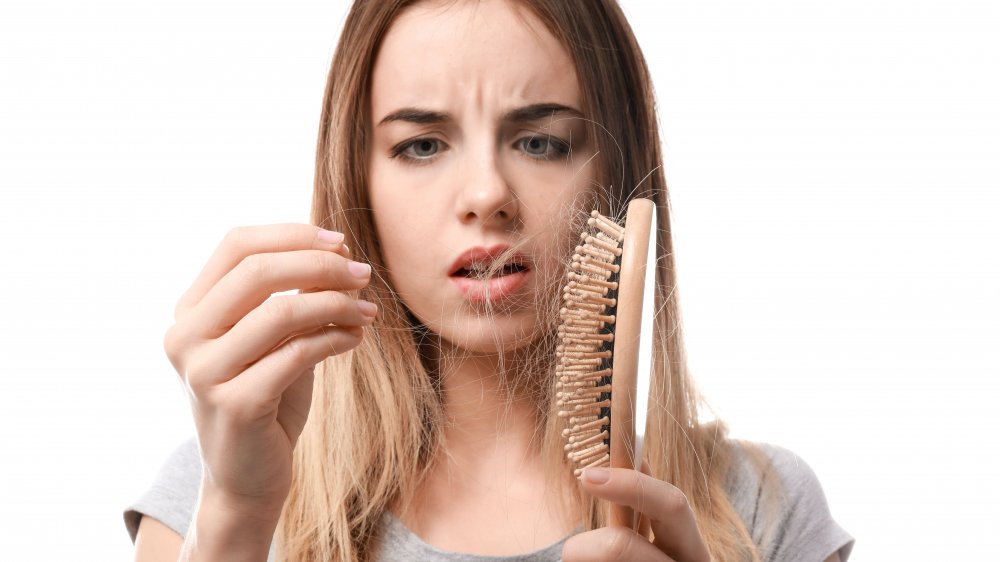 woman experiencing hair loss