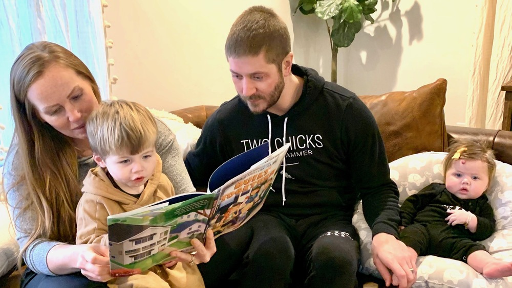 Mina Starsiak Hawk reading with her family 