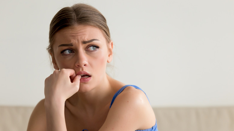 Worried woman feeling regrets after a breakup