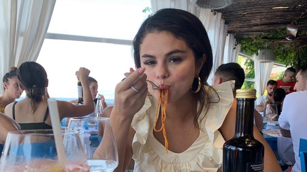 Selena Gomez eating pasta at a restaurant