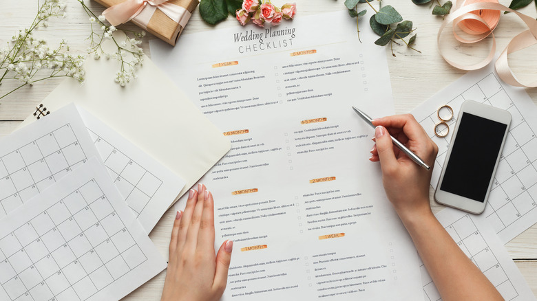 woman with planning checklist and calendars